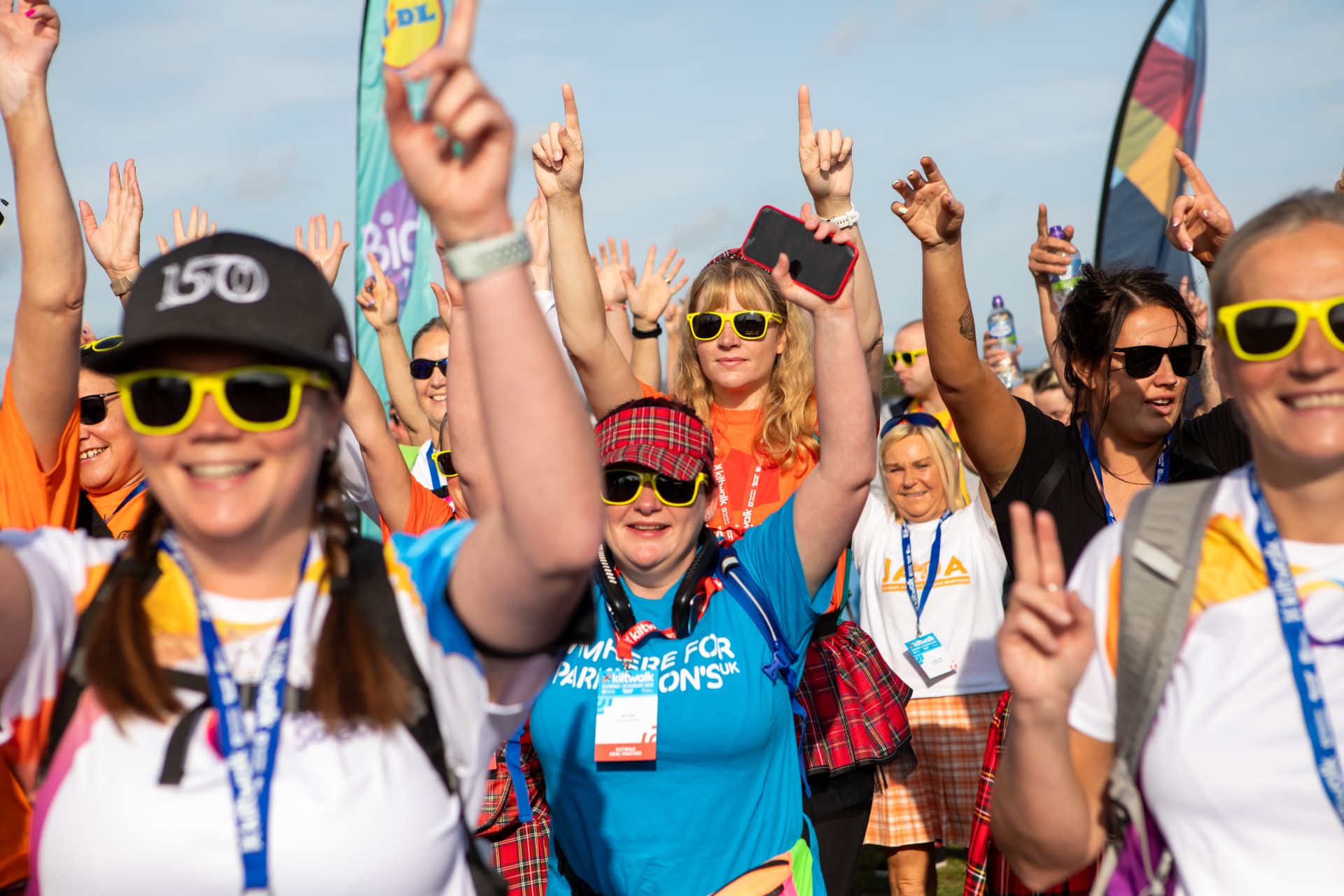 Kiltwalk participants cheering with their arms in the air